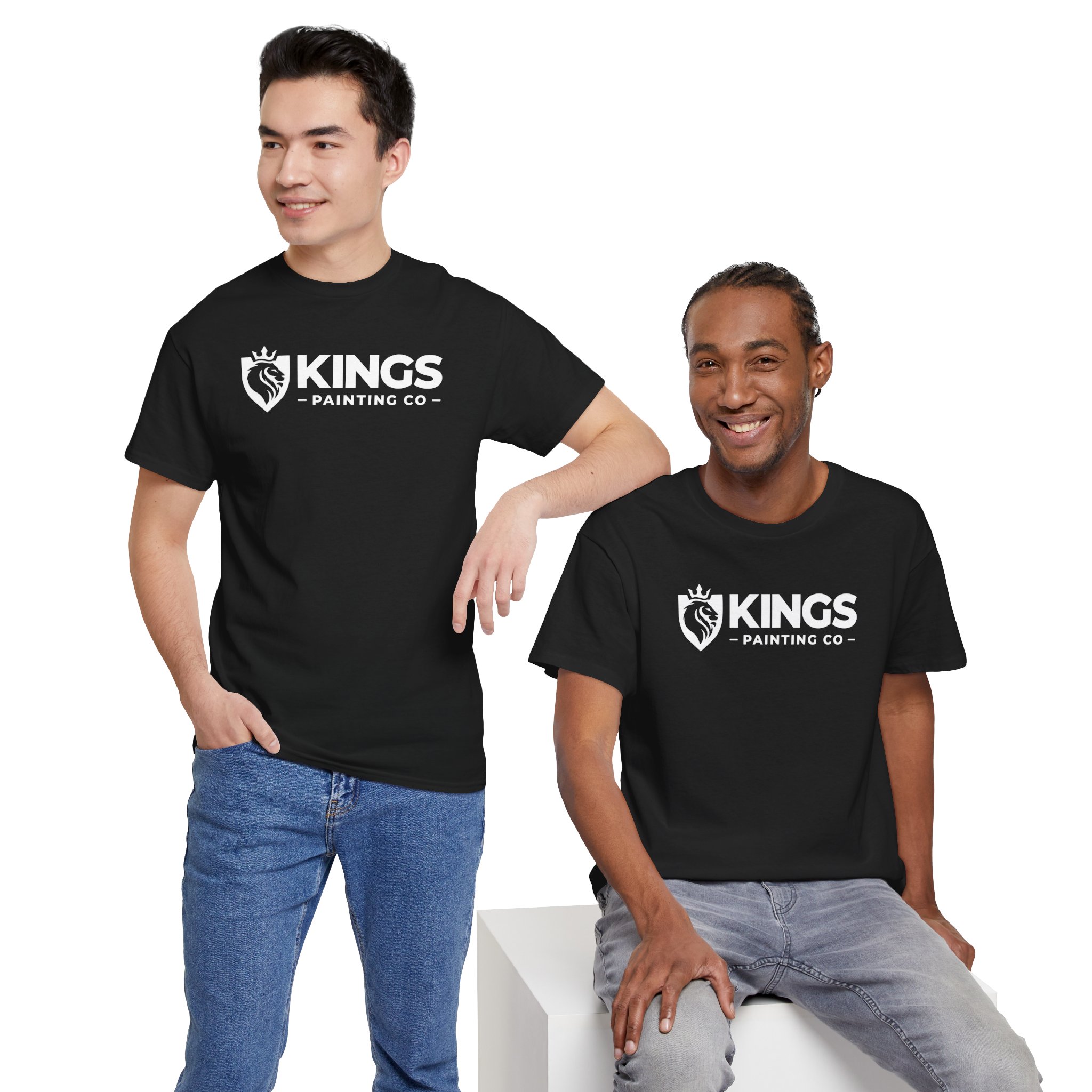 Two people in black Kings Painting Co. Logo T‑Shirts (Classic) | Gildan Ultra Cotton (G5000) pose together against a white background. One stands with a hand in his pocket, while the other sits, both smiling.